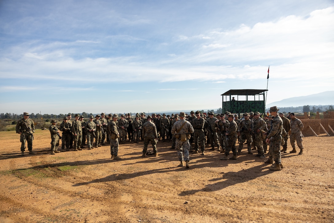 U.S. Marines with 1st Battalion, 25th Marines, 4th Marine Division and Chilean Marines receive a safety brief before they participate in a live fire exercise during exercise Southern Star 25, at Fuerte Aguayo, Chile, May 29, 2025. Southern Star is a multinational training exercise emphasizing operational and tactical missions, bringing together joint, combined, interagency, and military forces to strengthen coordination and interoperability within a unified special operations command. (U.S. Marine Corps photo by Lance Cpl. Payton Goodrich)