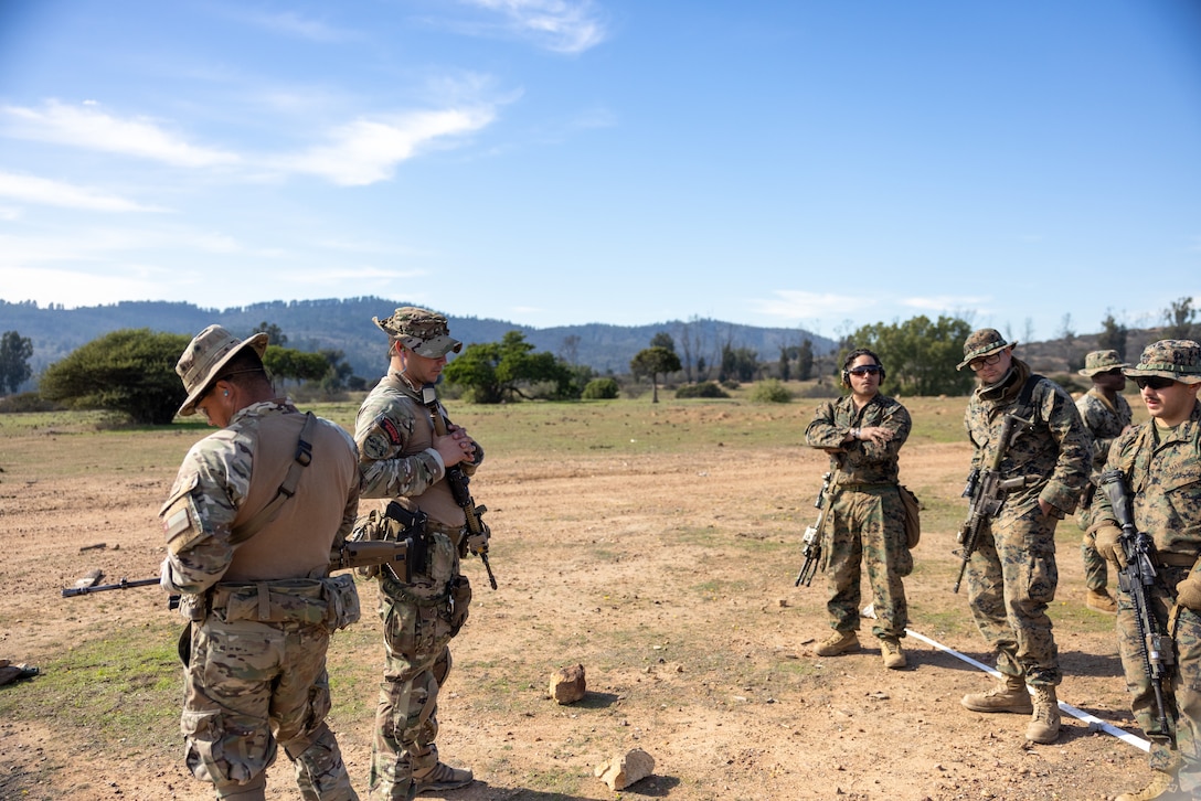 U.S. Marines with 1st Battalion, 25th Marines, 4th Marine Division and Chilean Marines receive a safety brief before they participate in a live fire exercise during Southern Star 25, at Fuerte Aguayo, Chile, May 29, 2025. Southern Star is a multinational training exercise emphasizing operational and tactical missions, bringing together joint, combined, interagency, and military forces to strengthen coordination and interoperability within a unified special operations command. (U.S. Marine Corps photo by Lance Cpl. Payton Goodrich)