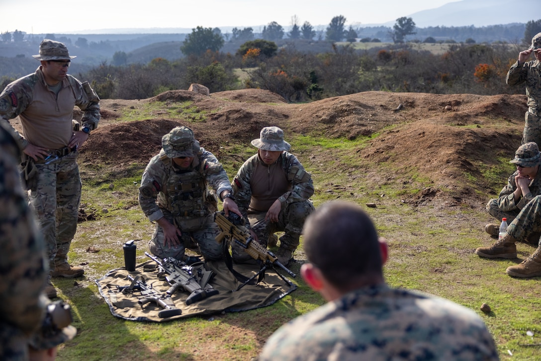 U.S. Marines gather for a class led by Chilean Marines on their weapons systems and how they operate them during a break from a live fire exercise during Southern Star 25, at Fuerte Aguayo, Chile, May 29, 2025. Southern Star is a multinational training exercise emphasizing operational and tactical missions, bringing together joint, combined, interagency, and military forces to strengthen coordination and interoperability within a unified special operations command. (U.S. Marine Corps photo by Lance Cpl. Payton Goodrich)
