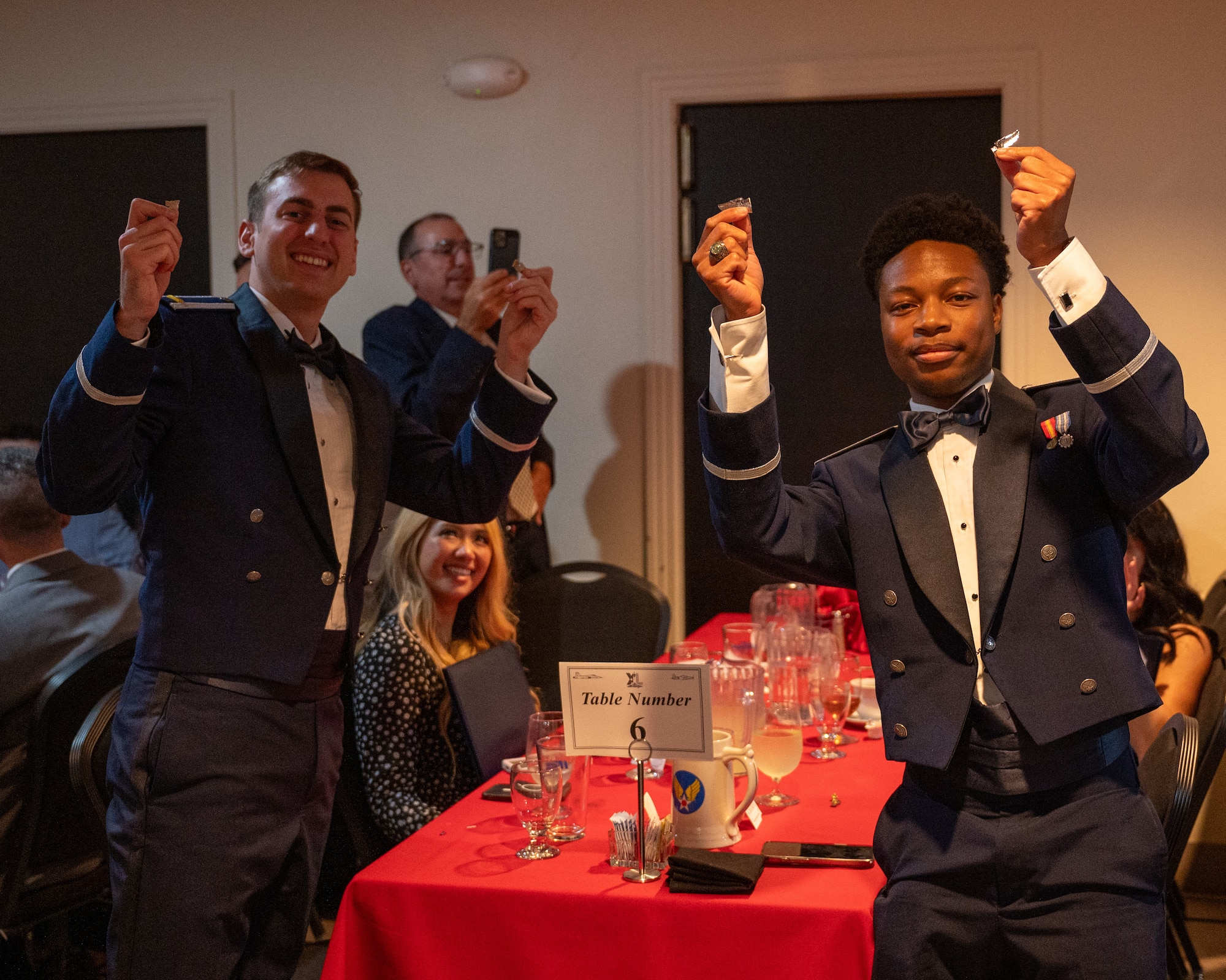 U.S. Air Force 2nd Lt. Quinten Moshy, left, 47th Student Squadron (STUS) pilot, and 2nd Lt. Donovan Williams, right, 47th STUS student pilot, show off their broken silver wings at Laughlin Air Force Base, Texas, May 29, 2025. The breaking of the wings is a tradition that reaches back to when the U.S. Army Air Corps first started issuing pilot wings, tradition states that the first pair of wings given are not to be worn, but broken and given to a loved one, with the two halves not to be reunited until the next life. (U.S. Air Force photo by Staff Sgt. Nicholas Larsen)