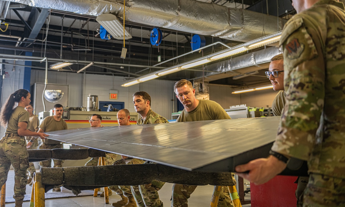U.S. Air Force Airmen assigned to the      23rd Maintenance Squadron collaborate to balance an aileron at Moody Air Force Base, Georgia, May 15, 2025. The aircraft structural maintenance unit completed its first aileron rebalancing after it was damaged and successfully repaired the HC-130J Combat King II control surfaces. (U.S. Air Force photo by Senior Airman Sir Wyrick)