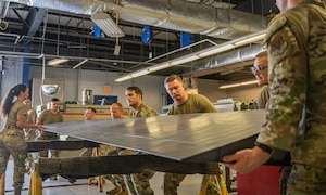 U.S. Air Force Airmen assigned to the      23rd Maintenance Squadron collaborate to balance an aileron at Moody Air Force Base, Georgia, May 15, 2025. The aircraft structural maintenance unit completed its first aileron rebalancing after it was damaged and successfully repaired the HC-130J Combat King II control surfaces. (U.S. Air Force photo by Senior Airman Sir Wyrick)