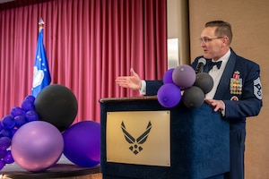 Man in dress uniform talks at podium