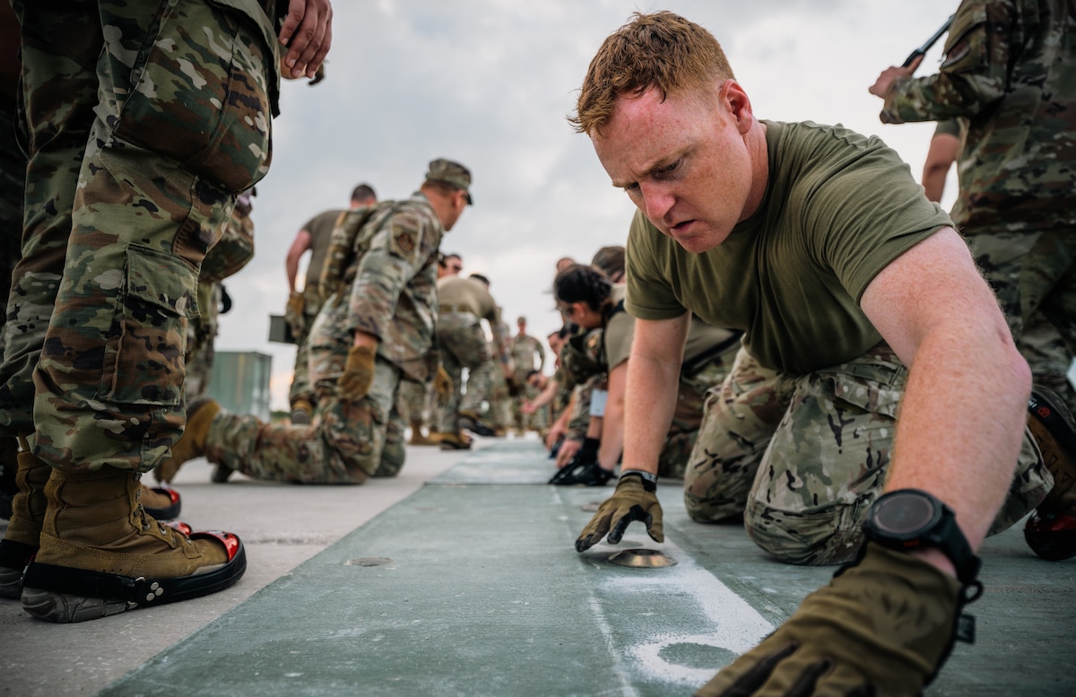 A male U.S. Airmen wearing gloves