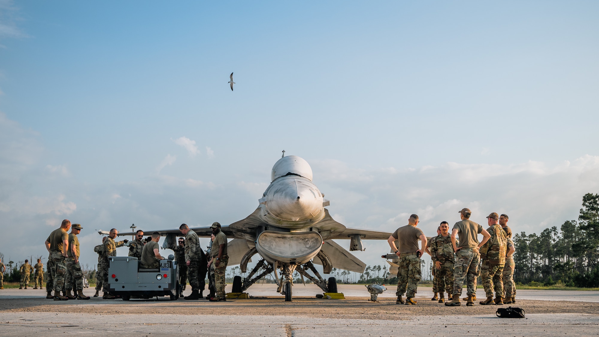 U.S. Airmen stnad around a fight jet