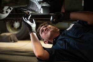 An Airman inspects fluid on the driveshaft of an R-11 Kovatch Refueler.