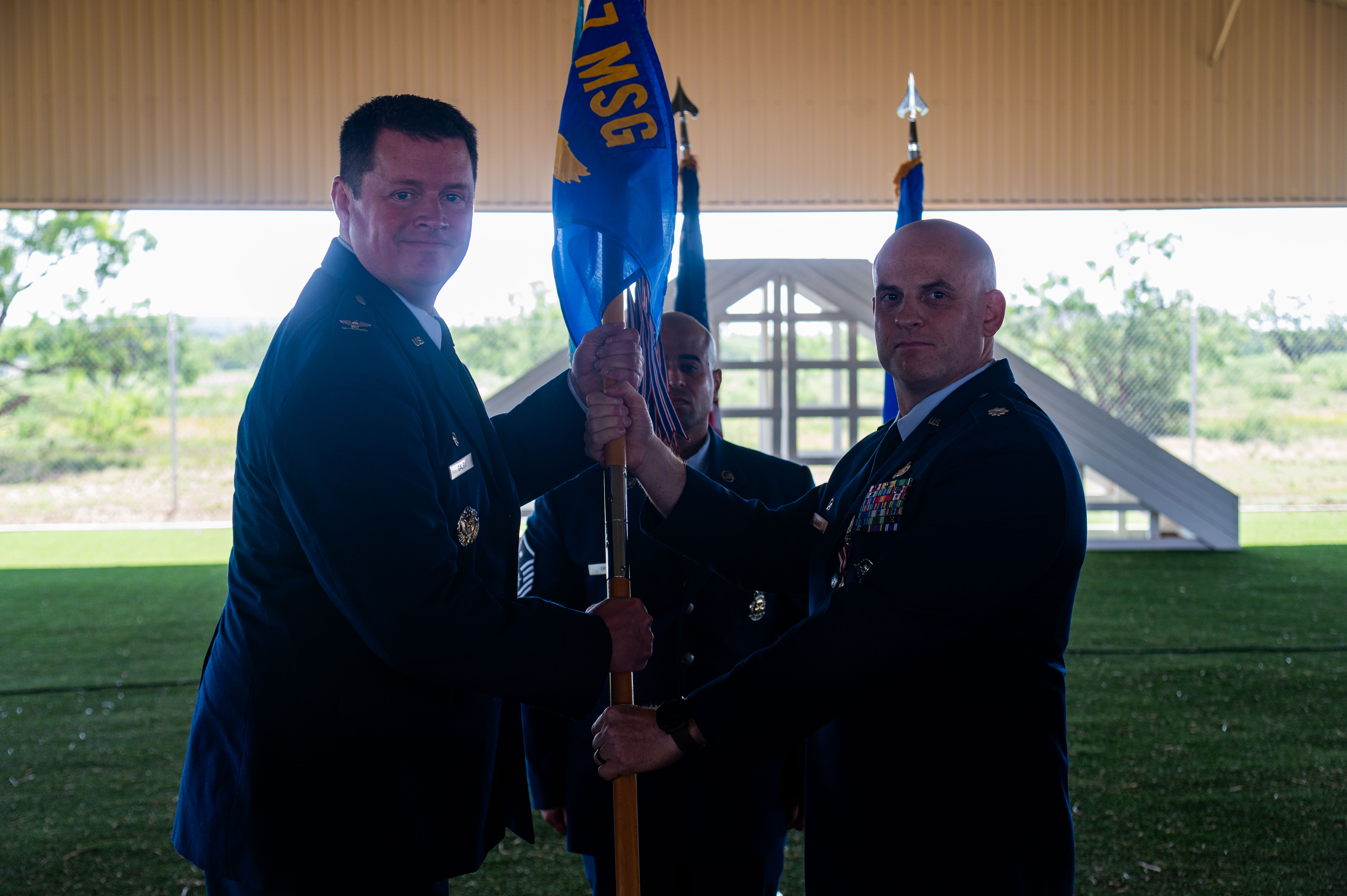 U.S. Air Force Col. Timothy Dalby, 17th Mission Support Group commander, takes the guidon from Lt. Col.Jeremy Berger, outgoing 17th Security Forces Squadron commander, during the change of command ceremony at the Military Working Dogs kennels’ overhang, Goodfellow Air Force Base, Texas, June 2, 2025. The 17th SFS provides unparalleled base defense and law enforcement services to Goodfellow AFB and supports contingency operations with world-class defenders. (U.S. Air Force photo by Airman 1st Class James Salellas)