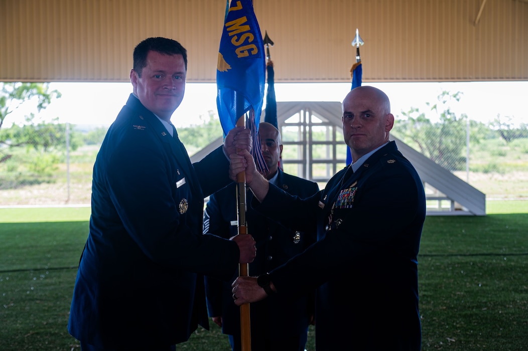 U.S. Air Force Col. Timothy Dalby, 17th Mission Support Group commander, takes the guidon from Lt. Col.Jeremy Berger, outgoing 17th Security Forces Squadron commander, during the change of command ceremony at the Military Working Dogs kennels’ overhang, Goodfellow Air Force Base, Texas, June 2, 2025. The 17th SFS provides unparalleled base defense and law enforcement services to Goodfellow AFB and supports contingency operations with world-class defenders. (U.S. Air Force photo by Airman 1st Class James Salellas)