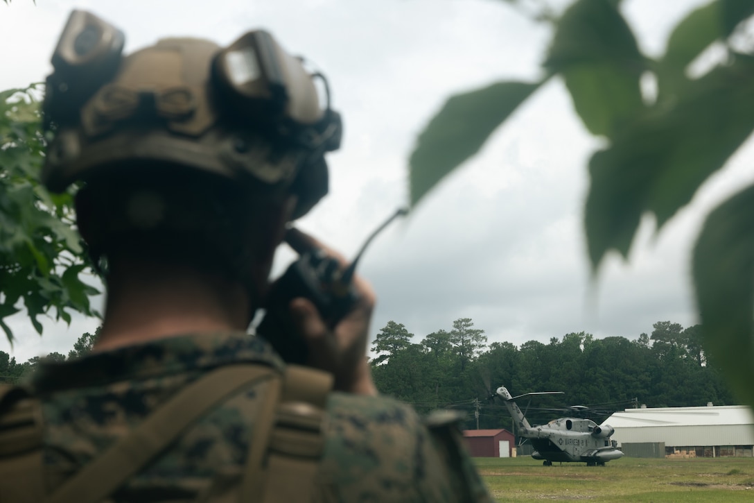 U.S. Marine Corps Sgt. Dennis McNabb, a squad leader with Lima Company, Battalion Landing Team 3/6, 22nd Marine Expeditionary Unit, listens for orders during a simulated non-combatant evacuation operation, as part of Iwo Jima Amphibious Ready Group Marine Expeditionary Unit exercise, at Marine Corps Base Stone Bay, North Carolina, May 28, 2025. During ARGMEUEX, the 22nd MEU, aboard IWOARG shipping, conducts various mission essential tasks that enhance operational readiness and lethality as a unified IWOARG/22 MEU team. (U.S. Marine Corps photo by Cpl. Maurion Moore)