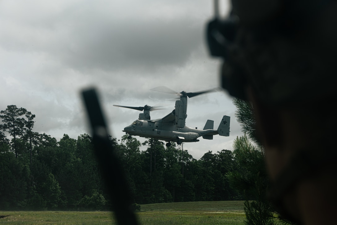 A U.S. Marine Corps MV-22B Osprey with Marine Medium Tiltrotor Squadron 263 (Reinforced), 22nd Marine Expeditionary Unit, prepares to land during a simulated non-combatant evacuation operation, as part of Iwo Jima Amphibious Ready Group Marine Expeditionary Unit exercise, at Marine Corps Base Stone Bay, North Carolina, May 28, 2025. During ARGMEUEX, the 22nd MEU, aboard IWOARG shipping, conducts various mission essential tasks that enhance operational readiness and lethality as a unified IWOARG/22 MEU team. (U.S. Marine Corps photo by Cpl. Maurion Moore)