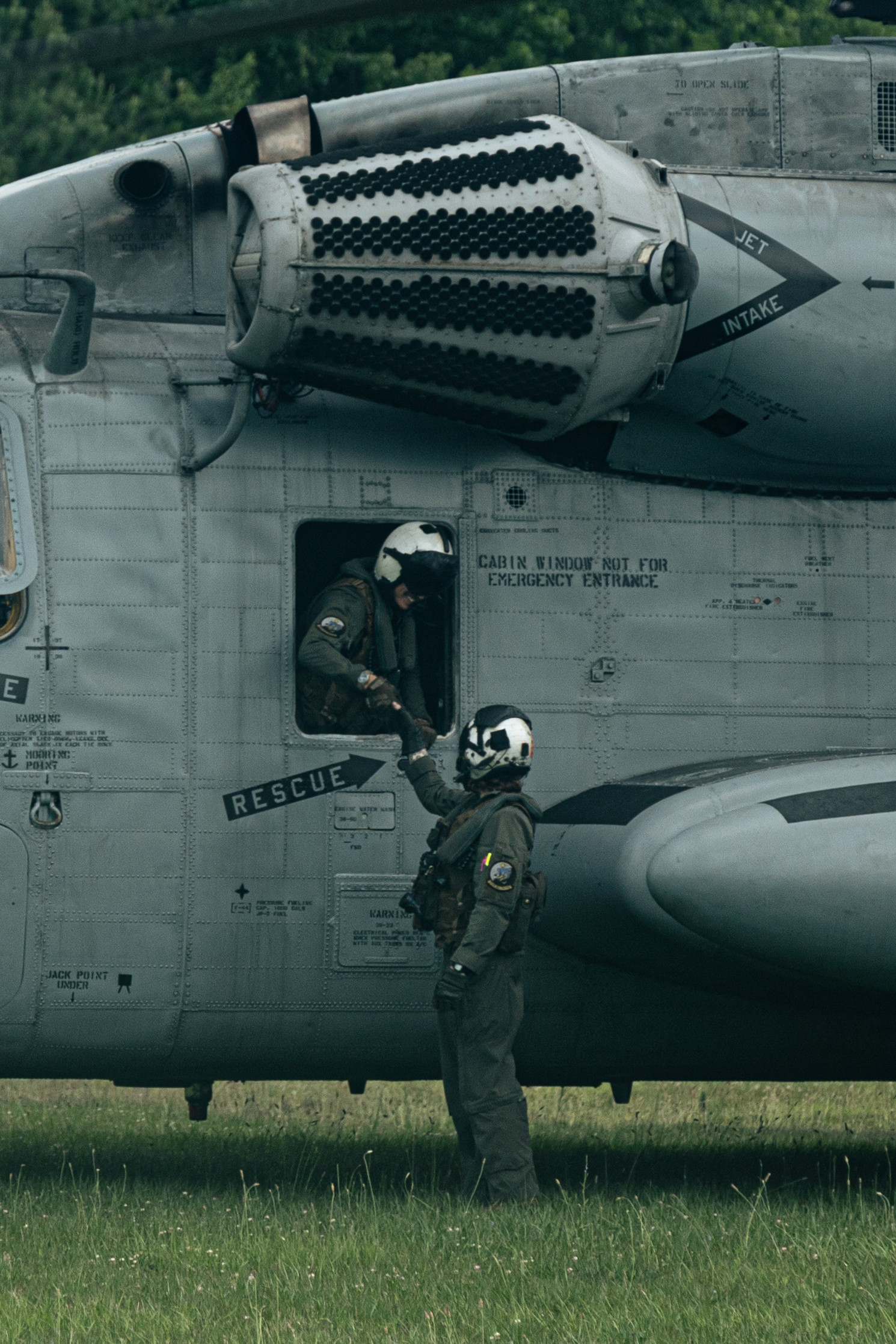U.S. Marines with Marine Medium Tiltrotor Squadron 263 (Reinforced), 22nd Marine Expeditionary Unit, speak parting words prior to take-off, during a simulated non-combatant evacuation operation, as part of Iwo Jima Amphibious Ready Group Marine Expeditionary Unit exercise, at Marine Corps Base Stone Bay, North Carolina, May 28, 2025. During ARGMEUEX, the 22nd MEU, aboard IWOARG shipping, conducts various mission essential tasks that enhance operational readiness and lethality as a unified IWOARG/22 MEU team. (U.S. Marine Corps photo by Cpl. Maurion Moore)
