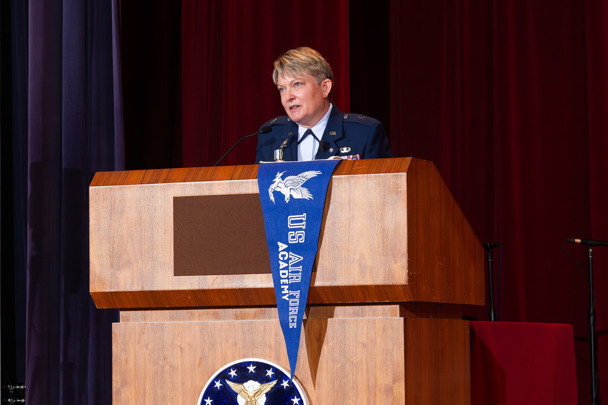 A photo of Brig. Gen. Linell Letendre at a podium giving a speech during her retirement ceremony