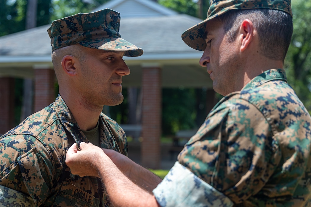 U.S. Navy Religious Program Specialist 1st Class Dominic Cicale, a Sailor with the 26th Marine Expeditionary Unit and a native of Illinois, is frocked with the rank of Petty Officer 1st class by Senior Chief Hospital Corpsman Michael Devito, the medical senior enlisted leader for the 26th MEU and a native of Virginia, at Camp Lejeune, North Carolina, May 29, 2025. Promotion ceremonies highlight a significant achievement in a service member's career and are a testament to their commitment, master of duties and skills, and leadership capabilities. (U.S. Marine Corps Photo by Lance Cpl. Jack Labrador)