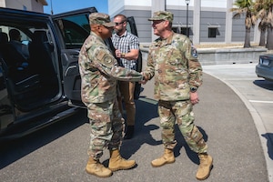 U.S. Space Force Lt. Gen. Douglas A. Schiess, U.S. Space Forces - Space (S4S) commander and Combined Joint Force Space Component commander, greets U.S. Air Force Gen. Anthony J. Cotton, United States Strategic Command commander, in front of S4S Headquarters at Vandenberg Space Force Base, Calif., May 30, 2025. S4S hosted Gen. Cotton to showcase the vital role space operations plays in strategic deterrence.