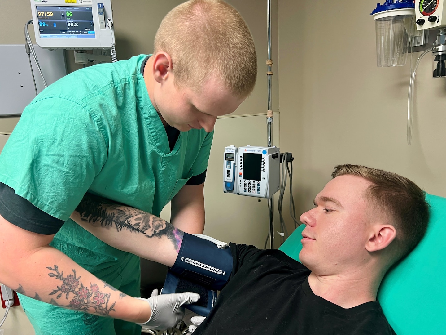 Male nurse taking patient's blood pressure.