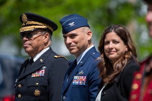 Image of three people participating in parade.