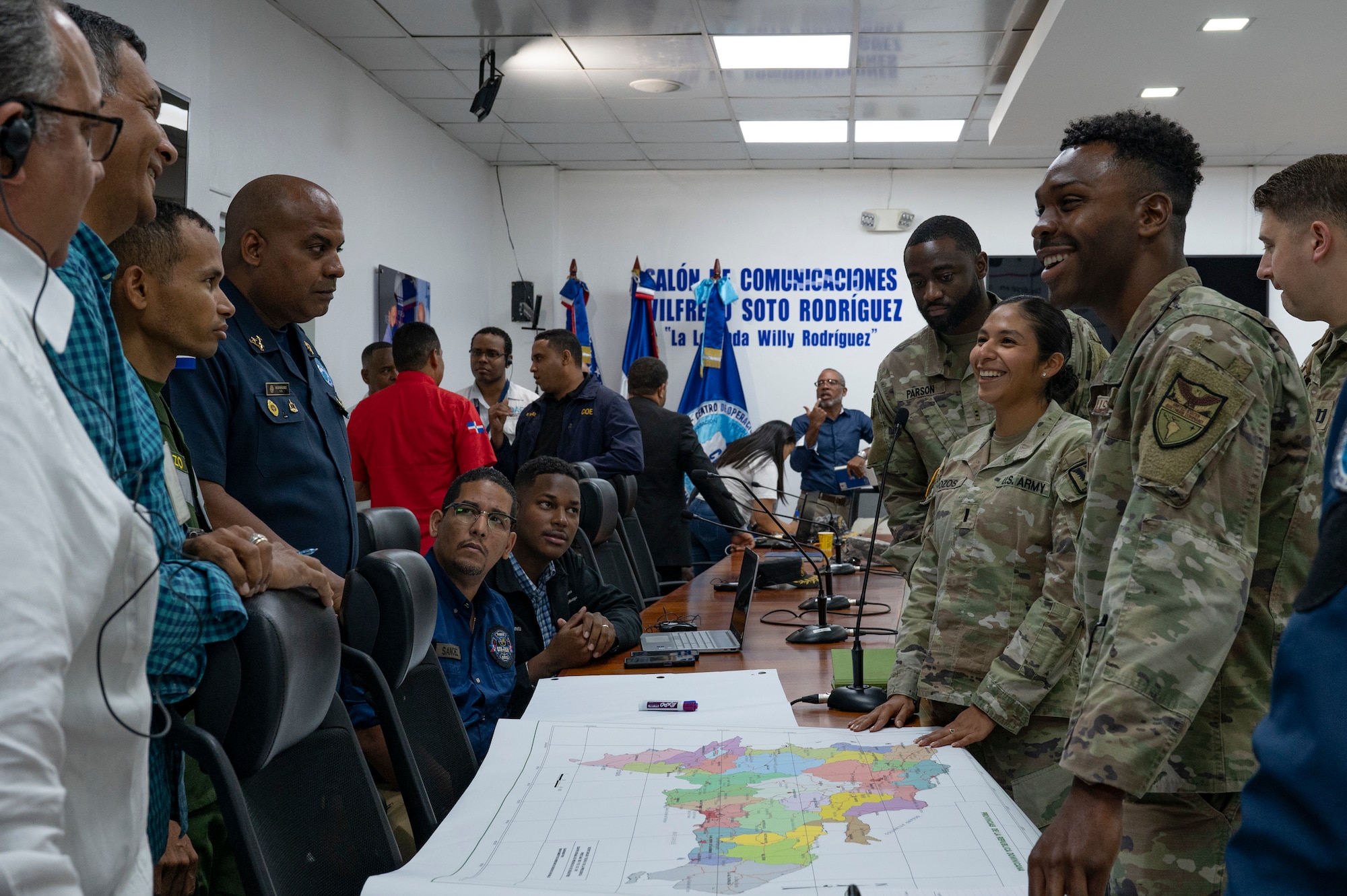 U.S. and Dominican Republic service members and Center of Emergency Operations personnel discuss solutions to an obstacle during a Jaguar Sentinel knowledge exchange in Santo Domingo, Dominican Republic, May 7, 2025. Each member presented their capabilities for the simulated disaster to help further synchronize their response for future operations. (U.S. Air Force photo by Staff Sgt. Sadie Colbert)