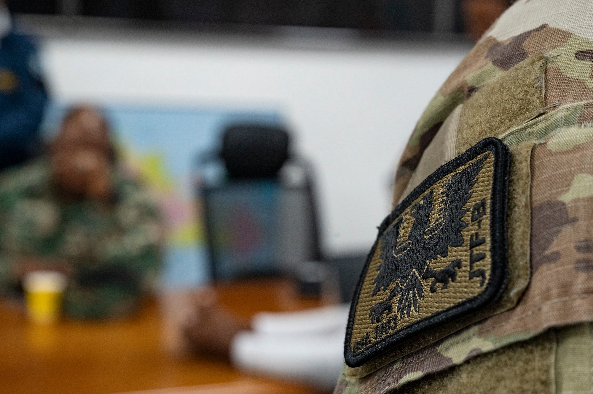 A U.S. Army member dons the Joint Task Force-Bravo heritage patch during a Jaguar Sentinel knowledge exchange in Santo Domingo, Dominican Republic, May 8, 2025. This was the inaugural Jaguar Sentinel knowledge exchange held at the Dominican Republic with scenarios created to challenge the group’s response techniques and procedures. (U.S. Air Force photo by Staff Sgt. Sadie Colbert)