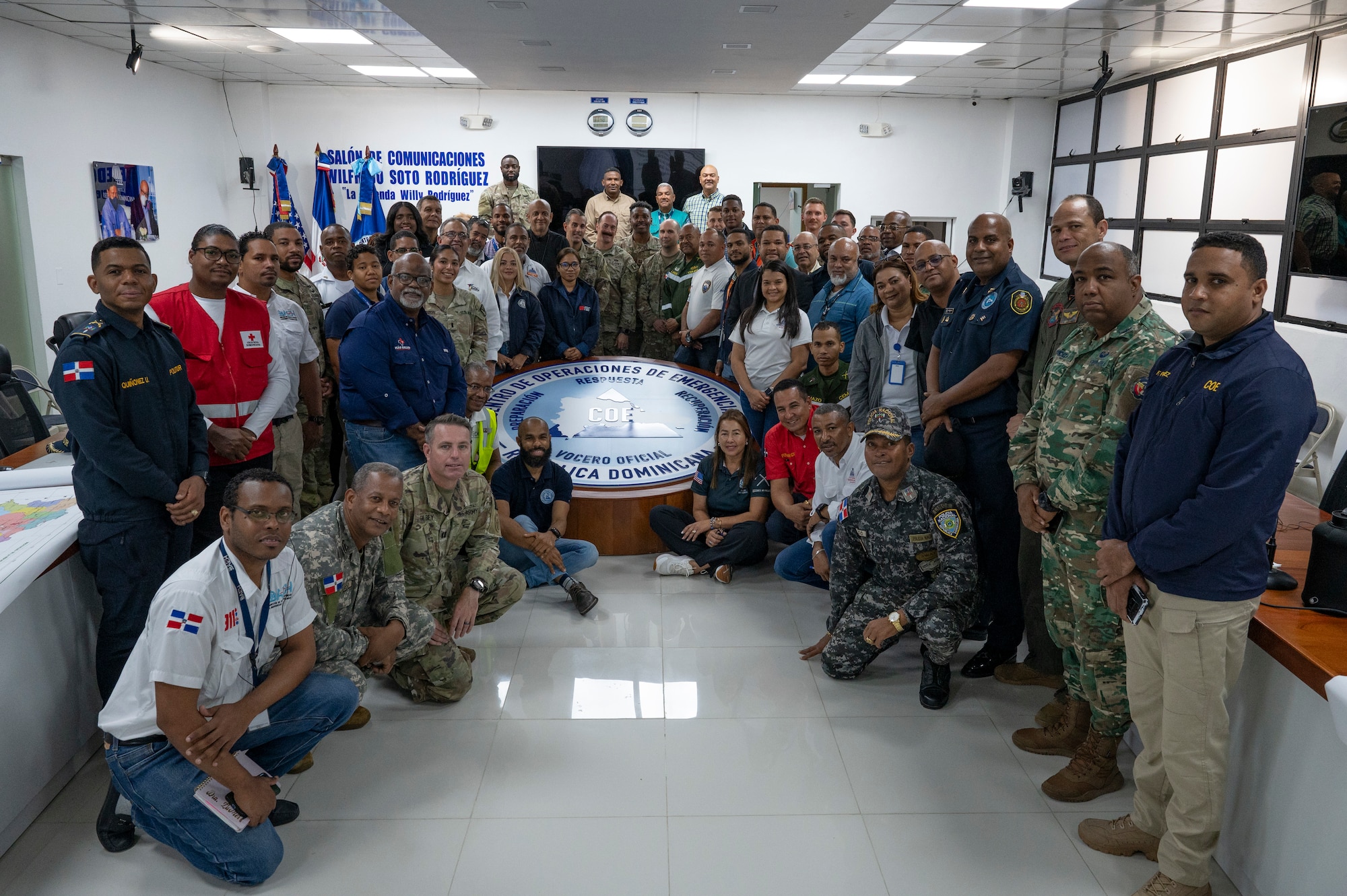 U.S. and Dominican Republic service members and Center of Emergency Operations personnel take a group photo during a Jaguar Sentinel knowledge exchange in Santo Domingo, Dominican Republic, May 8, 2025. The simulated scenario to a hurricane response tested how the Dominican Republic COE personnel would respond within the first 36 hours of a hurricane impacting the Southern region of the country until national help arrived. (U.S. Air Force photo by Staff Sgt. Sadie Colbert)