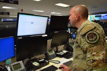 uniformed U.S. Airman works on a computer