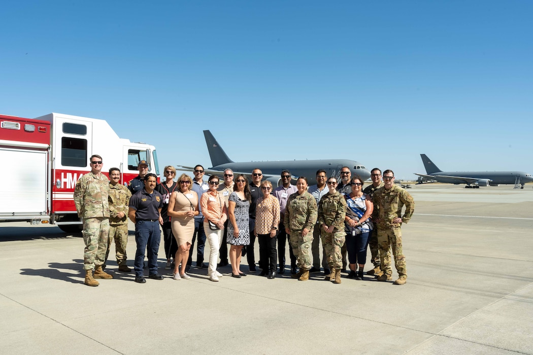 Honorary commanders assigned to the 60th Air Mobility Wing gather for a group photo on the flight line at Travis Air Force Base, California, May 9, 2025.