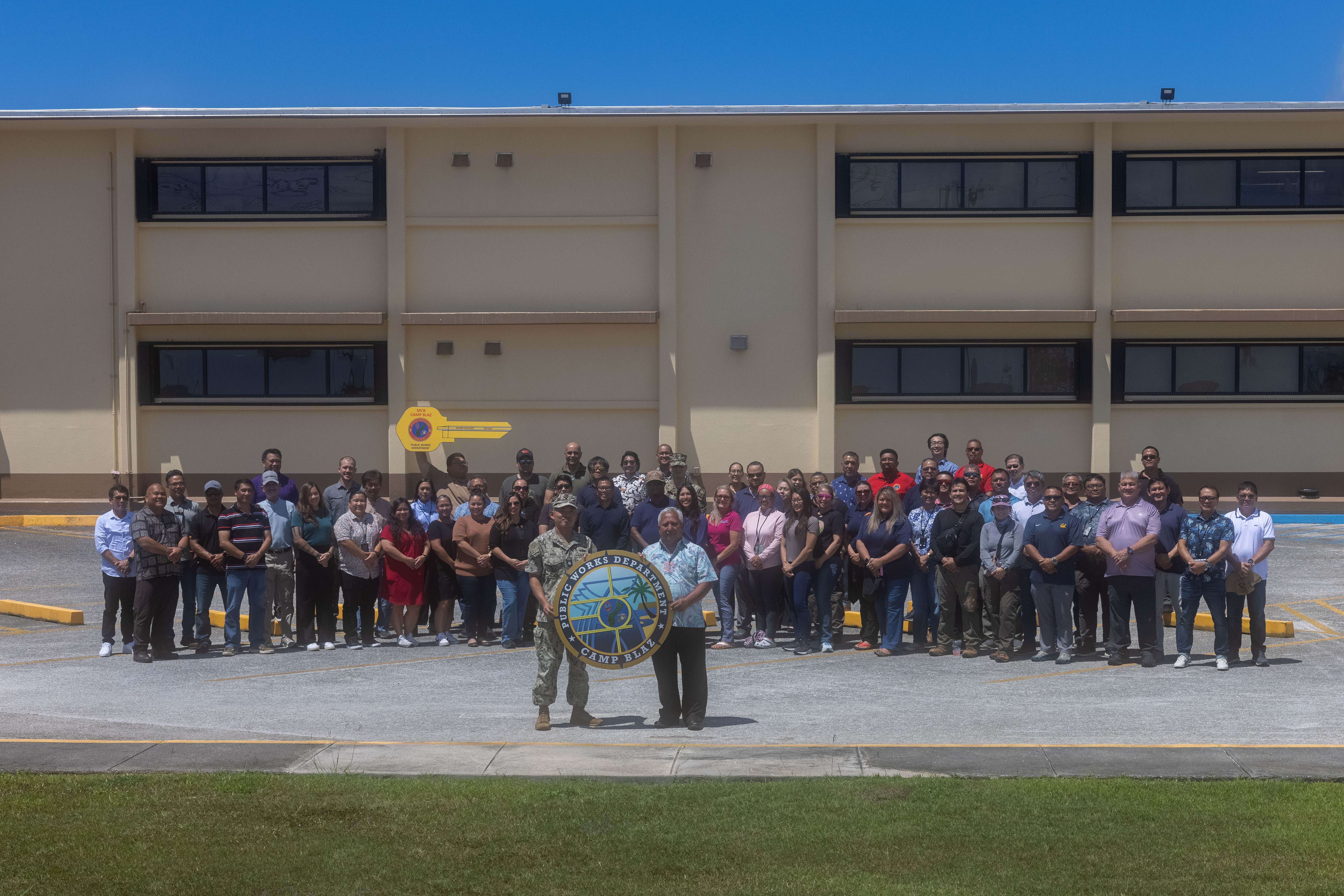 U.S. Navy sailors and civilians with Public Works Department, Marine Corps Base Camp Blaz pose for a group photo, MCB Camp Blaz, Guam, May 22, 2025. The Public Works Department team is celebrating National Public Works Week, May 18-24, and all their accomplishments toward the build up of Camp Blaz. (U.S. Marine Corps photo by Lance Cpl. Afton Smiley)