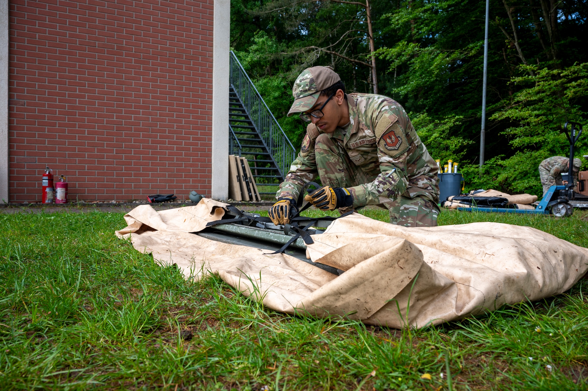U.S. Air Force Airman 1st Class Jakub Estrela, 786th Force Support Squadron readiness journeyman, bundles Single Pallet Expeditionary Kitchen (SPEK) pieces during Operation Steel at the 435th Construction and Training Squadron Compound near Ramstein Air Base, Germany, May 29, 2025.