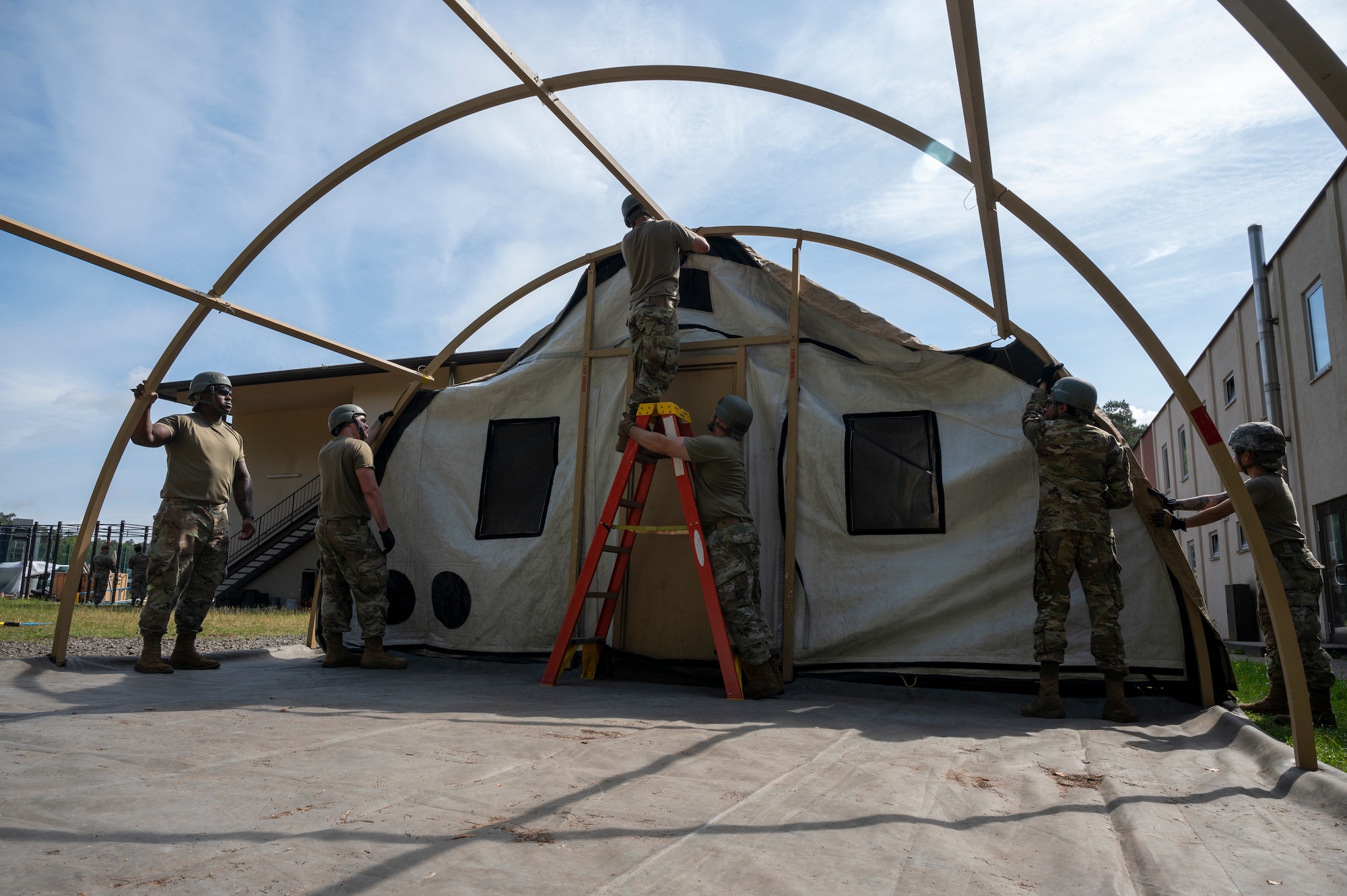 U.S. Airmen from the 786th Force Support Squadron construct an Alaska Small Shelter System during Operation Steel at the 435th Construction and Training Squadron Compound near Ramstein Air Base, Germany, May 29, 2025.