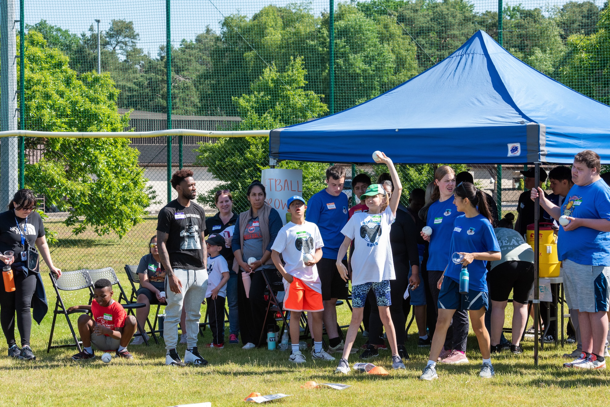 A student throws a softball.