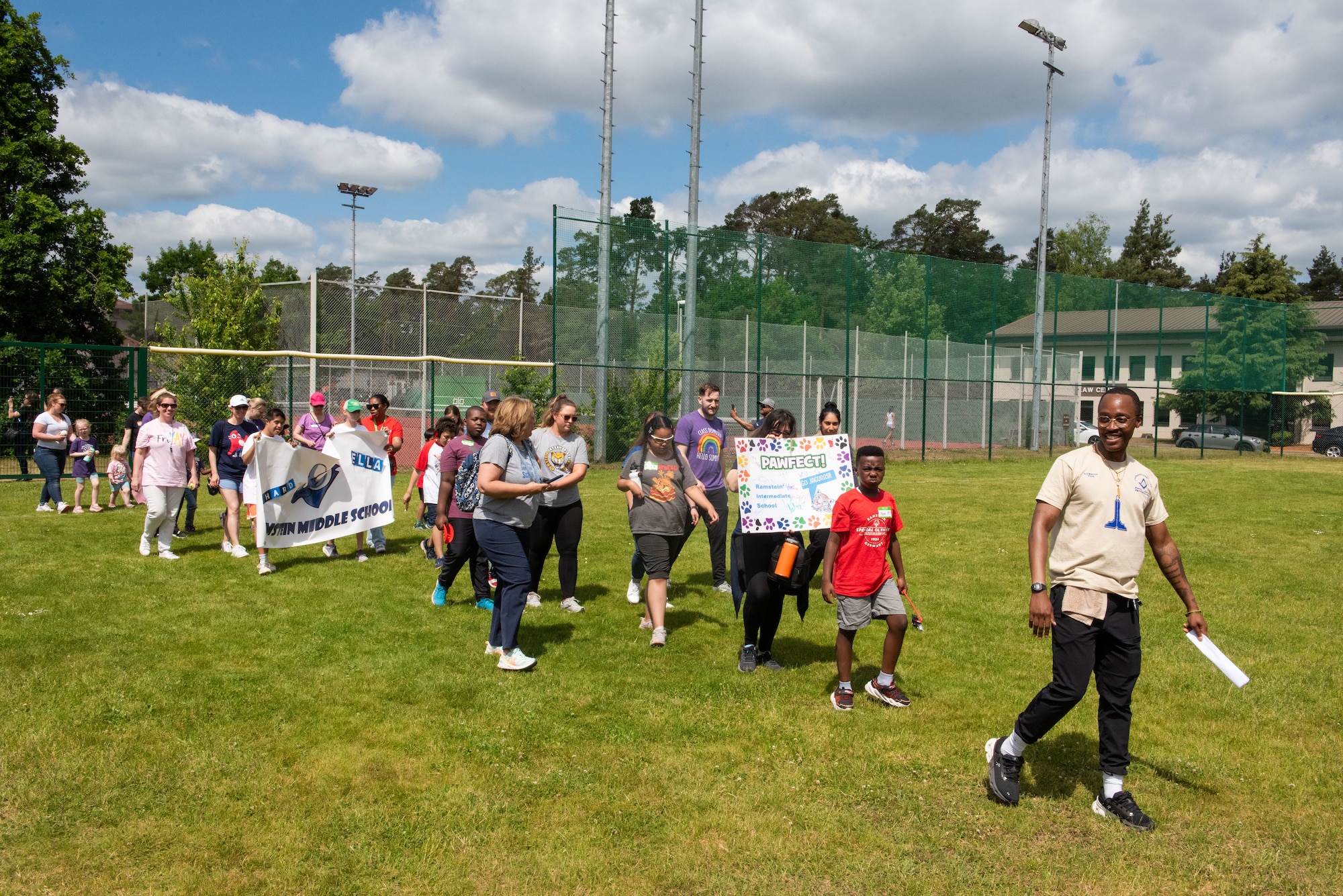 Students, school staff, and parents participate in a parade