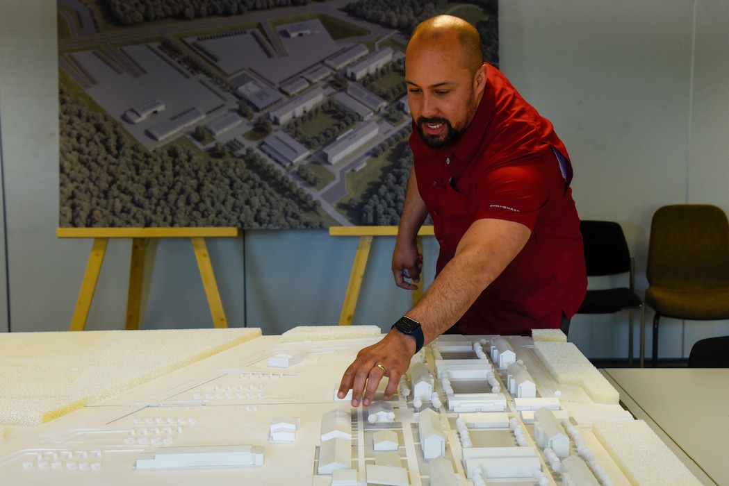 man pointing to 3D model on a table