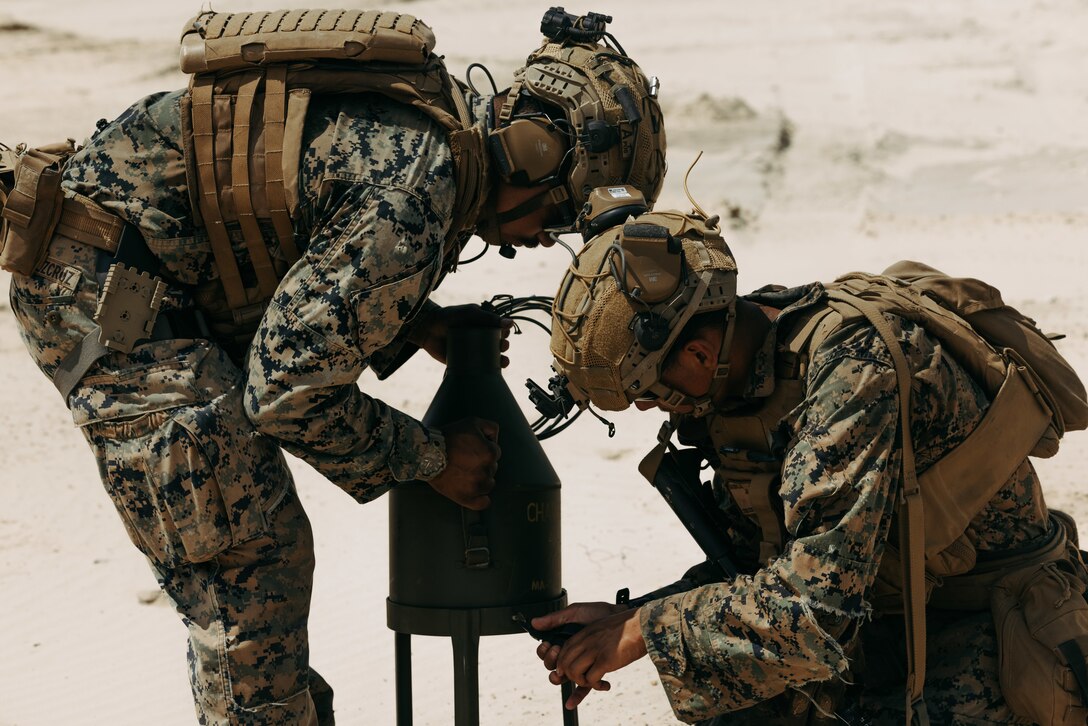 U.S. Marine Corps Sgt. Joshua M. MartinezCruz, left, and Lance Cpl. Jayden R. Hanson, both combat engineers with 2d Combat Engineer Battalion, 2d Marine Division, secure a cratering charge during a demolition range during the 2d CEB Marine Corps Combat Readiness Evaluation on Marine Corps Base Camp Lejeune, North Carolina, May 21, 2025. During the MCCRE, Marines and Sailors demonstrated combat proficiency in 13 engineering specialties required for mission essential tasks to ensure readiness for any conflict or operation. (U.S. Marine Corps photo by Lance Cpl. Alexandria Serrano)