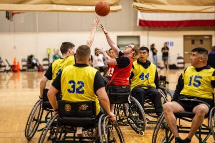 U.S. Army Spc. Sydney Cavanagh, red jersey, shoots the basketball over a defender during wheelchair basketball at the 2025 Army Trials, Fort Bliss, Texas, April 3, 2025.