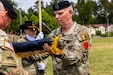 U.S. Army Col. Christopher Costello, commander of the 56th Stryker Brigade Combat Team, Pennsylvania National Guard, cases the brigade colors at the Joint Multinational Training Group-Ukraine transfer of authority ceremony at Tower Barracks, Grafenwoehr, Germany, June 1, 2025. The ceremony commemorated the transfer of the JMTG-U mission from the 56th SBCT to the 278th Armored Cavalry Regiment, Tennessee National Guard. (U.S. Army National Guard photo by Capt. Leanne Demboski)