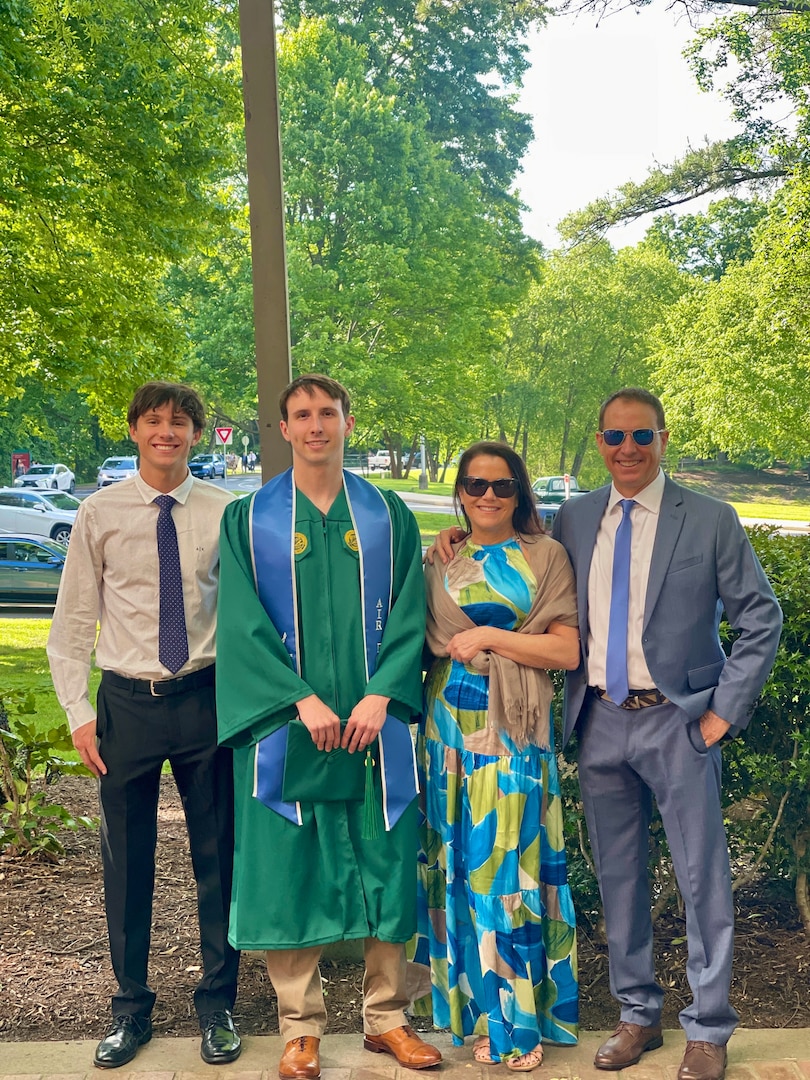 Senior Airman Corbin Phillips, crew chief within the 113th Wing Maintenance Squadron, D.C. Air National Guard, stands for a photograph with his family following a commencement ceremony, in Fairfax, VA, on May 15, 2025. SrA Phillips completed a Bachelor of Science in Systems and Industrial Engineering with the assistance of the District of Columbia National Guard Tuition Assistance Program.