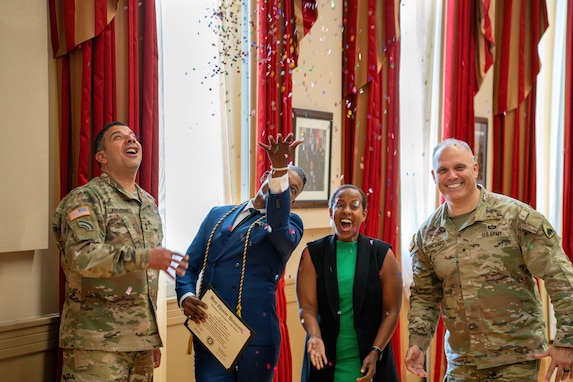 Maj. Gen. John C. Andonie, Commanding General (Interim) for the D.C. National Guard; Brig. Gen. Leland D. Blanchard II, the Adjutant General for the D.C. National Guard; Master Sgt. Arthur Mondale Wright, State Public Affairs Officer, and Ms. Ayan Sheikh, State Public Affairs Office specialist celebrate with confetti at the D.C. Armory, in Washington D.C., on May 21, 2025. Master Sgt. Wright completed a Master of Public Administration with the assistance of the District of Columbia National Guard Tuition Assistance Program.