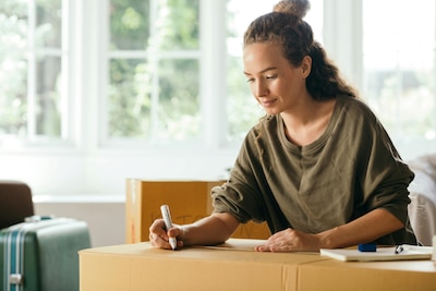 Woman writes at a desk.