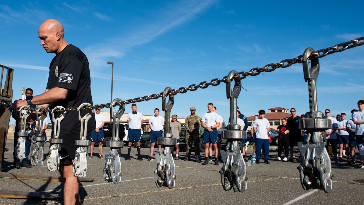 Airman hangs memorial device during ceremony