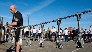 Airman hangs memorial device during ceremony
