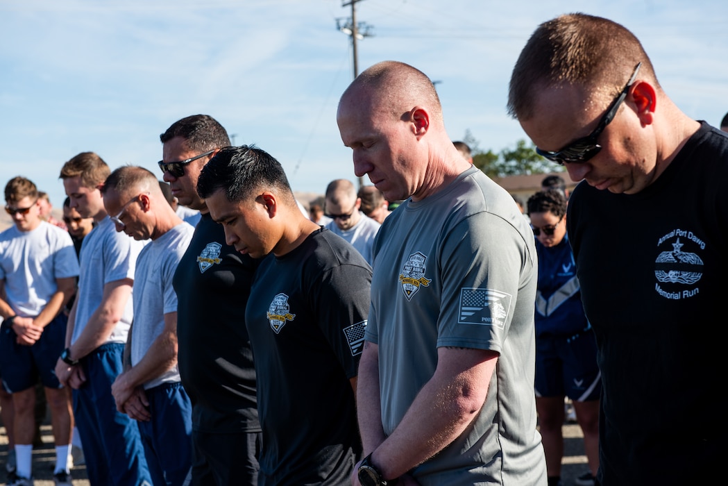 Airmen bow heads during moment of silence