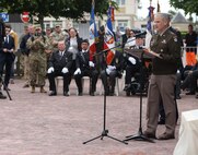 U.S. Army Lt. Gen. Charles Costanza, commanding general of V Corps, speaks beneath a statue of Gen. Dwight D. Eisenhower in Sainte-Mère-Église, France, June 2, 2025. The statue, unveiled in 2024, honors Eisenhower’s legacy and symbolizes Allied unity. (U.S. Army photo by Sgt. Tyler Brock)