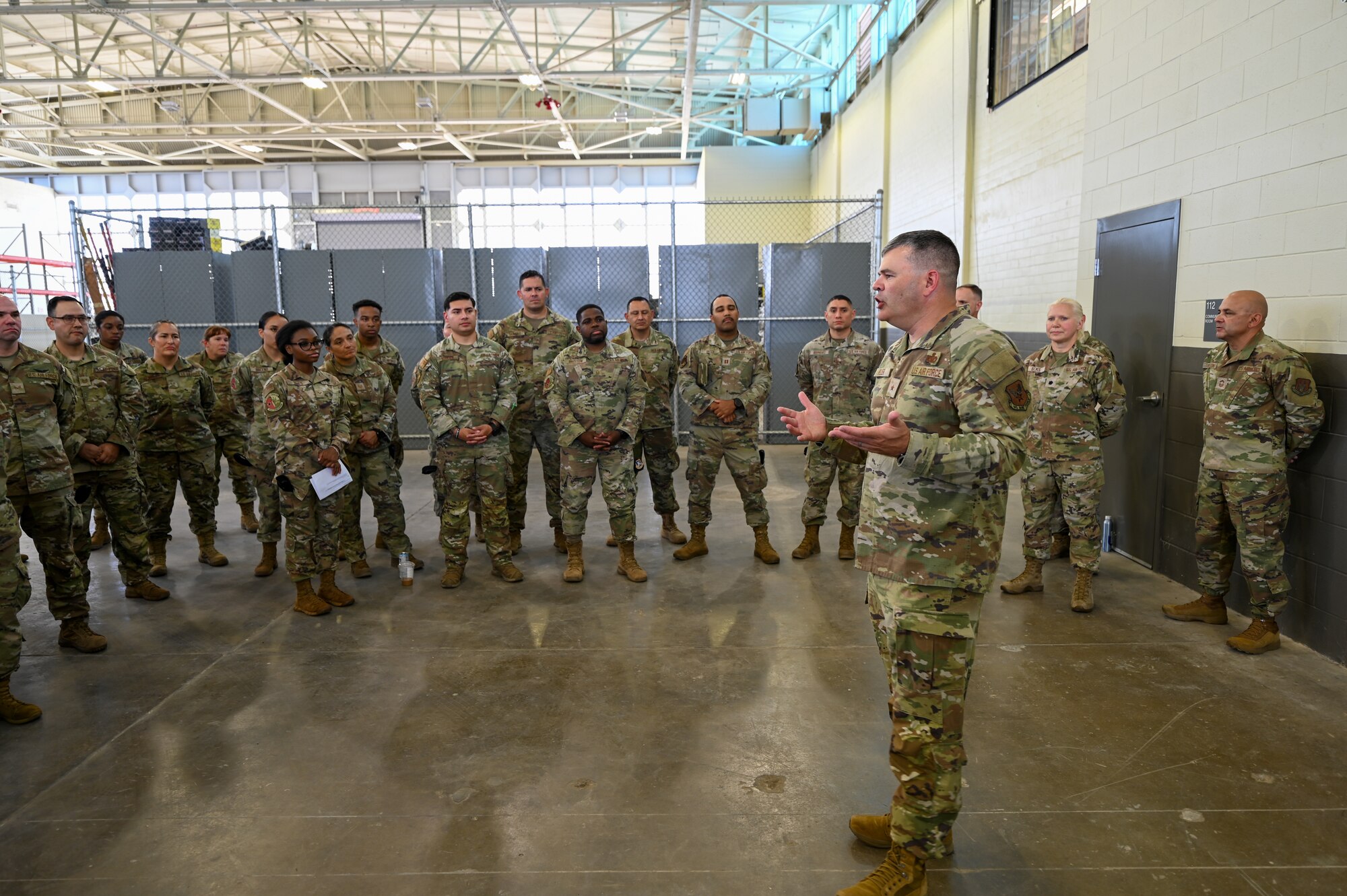 Brig. Gen. Brian A. Filler, Director of Security Forces, Deputy Chief of Staff for Logistics, Engineering and Force Protection, Headquarters U.S. Air Force, talks with 433rd Security Forces Citizen Airmen, and 149th SFS Guardsmen during a tour of the 433rd SFS at Joint Base San Antonio-Lackland, Texas, May 3, 2025.