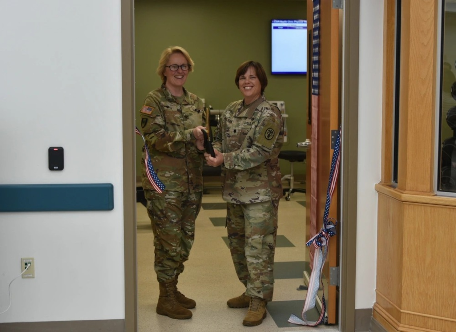 Col. Stephanie Mont, Womack Army Medical Center Hospital Commander and Lt. Col. (P) Melissa Folsom, director, Rehabilitation Services cut ribbon during May 14 ceremony. Clark Health Clinic Ribbon Cutting ceremony celebrates a nearly decades-long initiative to establish full scope Physical Therapy services embedded within the Clark Health Clinic, allowing Soldiers to complete their medical services within one footprint, Womack Army Medical Center, Fort Bragg, North Carolina