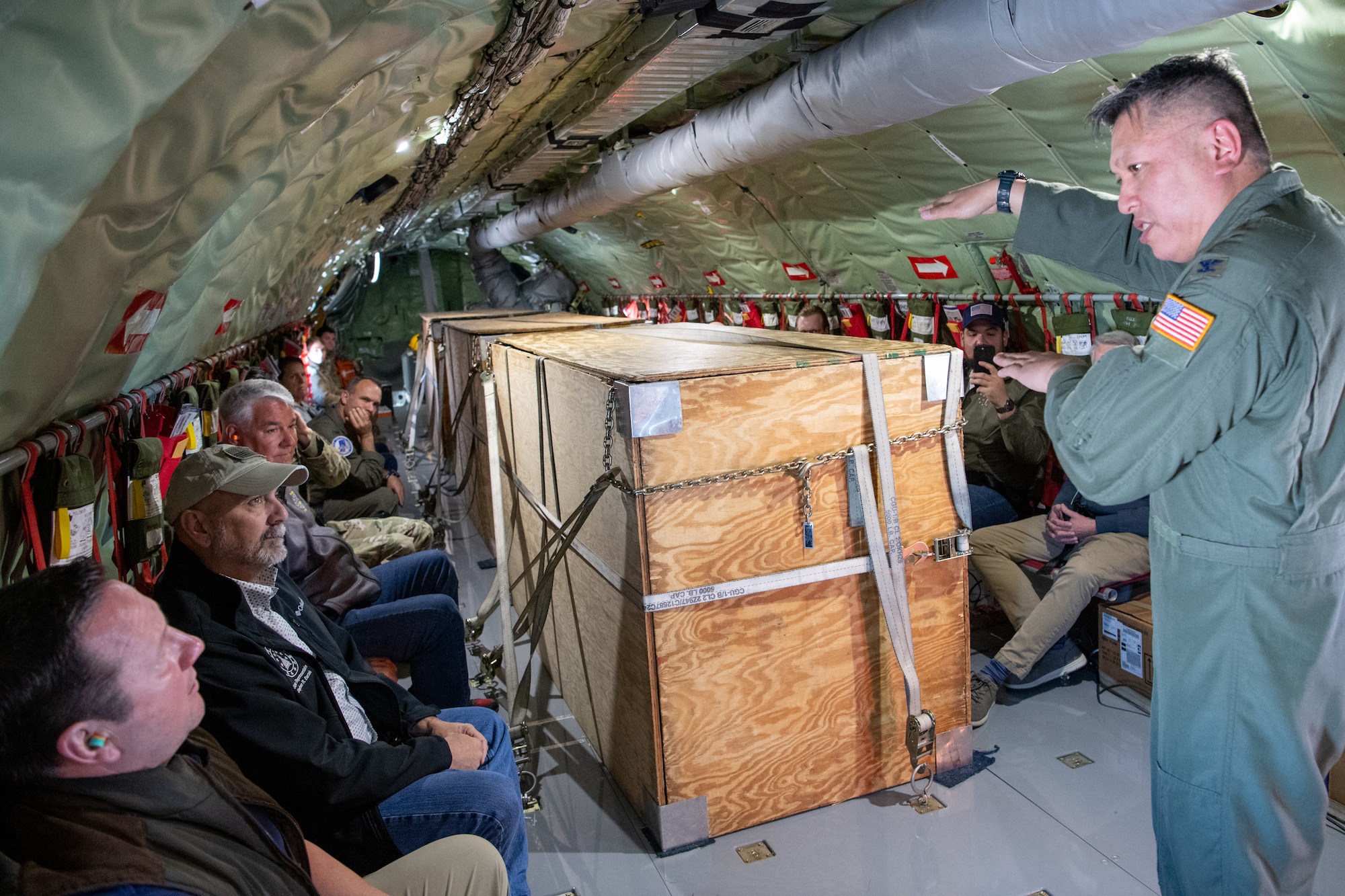 Col. Van Thai, 434th Air Refueling Wing commander, explains aerial refueling to a group of Indiana state legislators during a refueling mission over Central Indiana, May 29, 2025. The base partnered with the 122nd Fighter Wing, Fort Wayne, Ind., to demonstrate the joint capabilities of the Indiana National Guard and Air Force Reserve. (U.S. Air Force photo/Ben Mota)