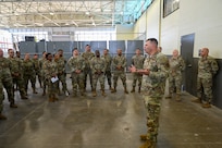 Brig. Gen. Brian A. Filler, Director of Security Forces, Deputy Chief of Staff for Logistics, Engineering and Force Protection, Headquarters U.S. Air Force, talks with 433rd Security Forces Citizen Airmen, and 149th SFS Guardsmen during a tour of the 433rd SFS at Joint Base San Antonio-Lackland, Texas, May 3, 2025.
