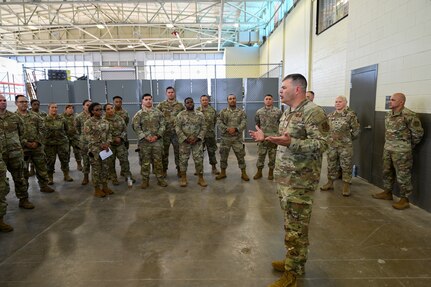 Brig. Gen. Brian A. Filler, Director of Security Forces, Deputy Chief of Staff for Logistics, Engineering and Force Protection, Headquarters U.S. Air Force, talks with 433rd Security Forces Citizen Airmen, and 149th SFS Guardsmen during a tour of the 433rd SFS at Joint Base San Antonio-Lackland, Texas, May 3, 2025.
