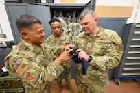 Technical Sgt. Daniel Cruz, 433rd Security Forces supply non-commissioned officer, shows Brig. Gen. Brian A. Filler, Director of Security Forces, Deputy Chief of Staff for Logistics, Engineering and Force Protection, Headquarters U.S. Air Force, the new night vision devices during a tour of the 433rd SFS unit at Joint Base San Antonio-Lackland, Texas, May 3, 2025.