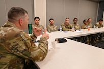 Brig. Gen. Brian A. Filler, Director of Security Forces, Deputy Chief of Staff for Logistics, Engineering and Force Protection, Headquarters U.S. Air Force, sits down with junior enlisted defenders from the 433rd Security Forces Squadron during a tour of the 433rd SFS at Joint Base San Antonio-Lackland, Texas, May 3, 2025.