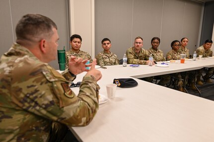 Brig. Gen. Brian A. Filler, Director of Security Forces, Deputy Chief of Staff for Logistics, Engineering and Force Protection, Headquarters U.S. Air Force, sits down with junior enlisted defenders from the 433rd Security Forces Squadron during a tour of the 433rd SFS at Joint Base San Antonio-Lackland, Texas, May 3, 2025.