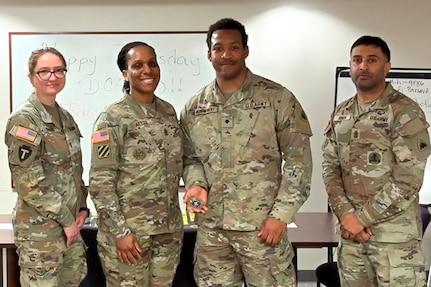 1st Lt. Natalia Khalifa, 1946th Theater Finance Company commander; Command Sgt. Maj. L. Allen, U.S. Army Financial Management Command senior enlisted advisor; with Spc. Devin Montgomery, 1946th Theater Finance Company disbursing analyst; and 1st Sgt. Sahib Singh, 1946th T-FICO first sergeant, pose for a photo at Joint Base Anacostia-Bolling, Washington, D.C., May 4. During her time with the 1946th T-FICO, Allen observed Soldiers conducting training in preparation for their upcoming annual training with a specific focus on disbursing operations. (U.S. Army photo)
